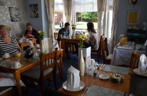 Guests enjoy a meal in the dining room of the Kilbrannan Guesthouse.